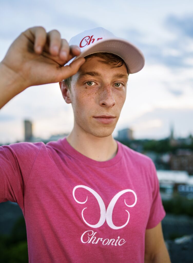 Person in pink shirt outdoors wearing cap