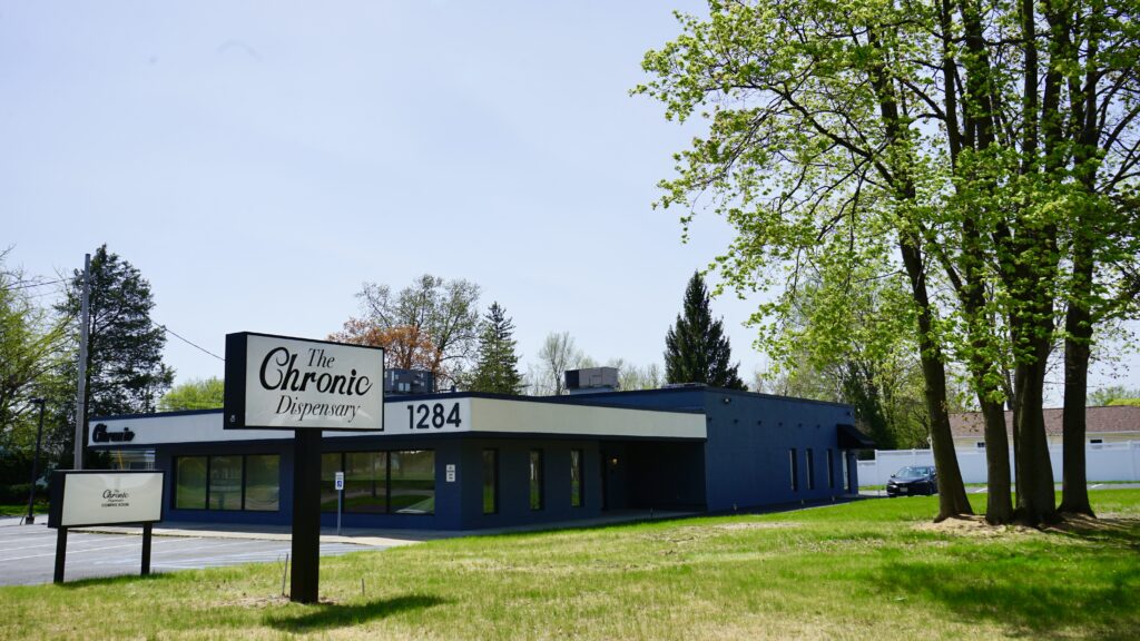 Chronic Dispensary building surrounded by trees.